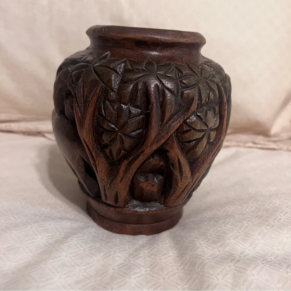 Carved wooden type vase with elephant. Approximately 6 inches high.